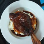 Slow cooked lamb shanks in red wine sauce on mash potato