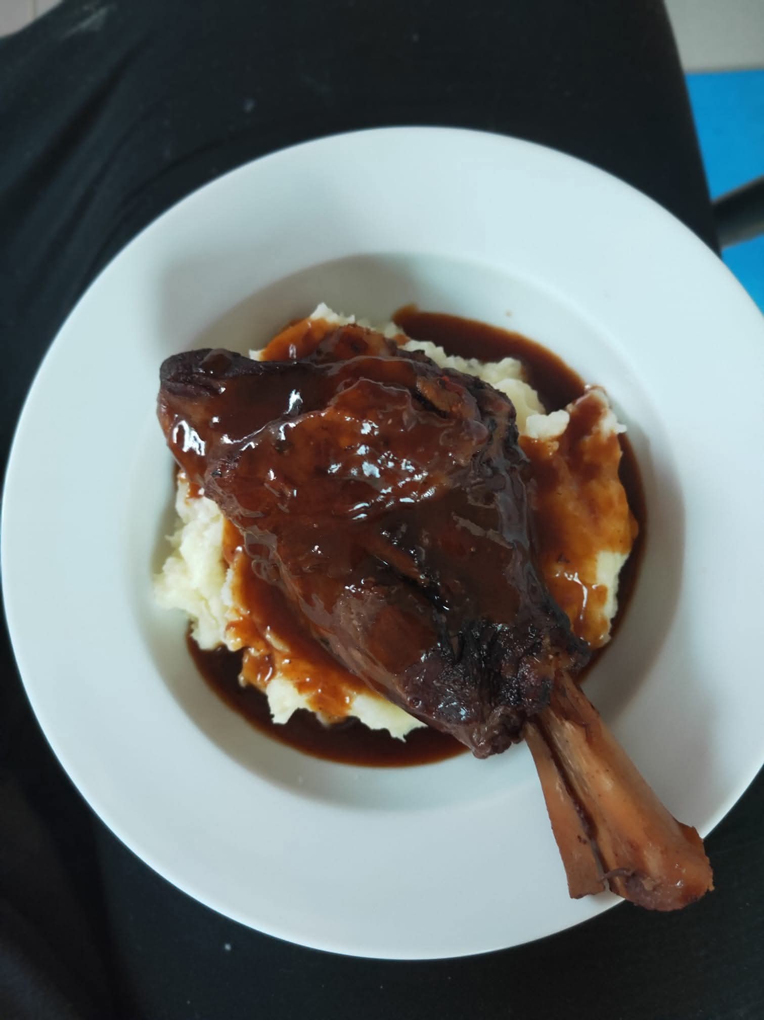 Slow cooked lamb shanks in red wine sauce on mash potato